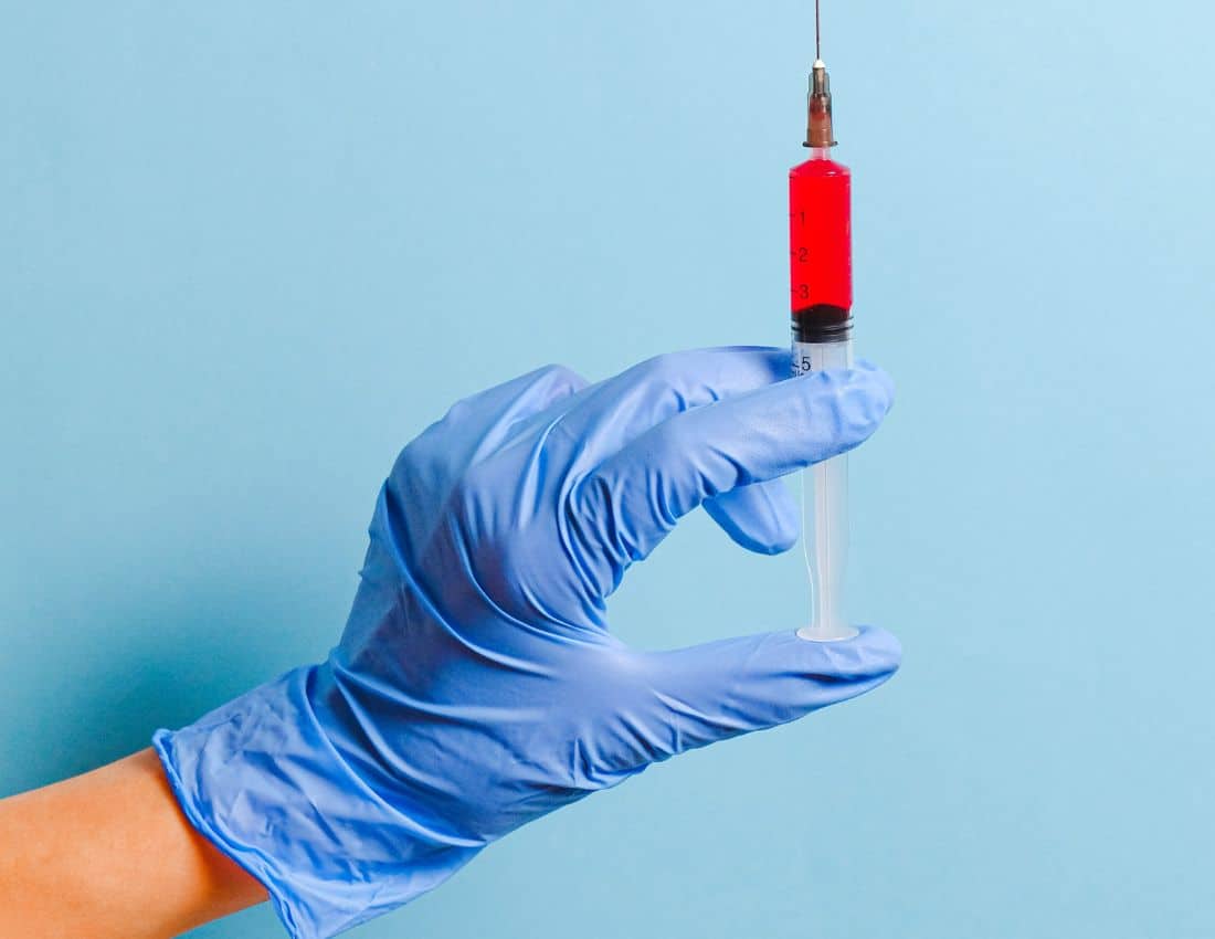 person-holding-syringe