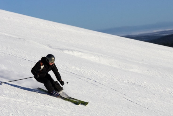 A person skiing down a snowy hill
Description automatically generated
