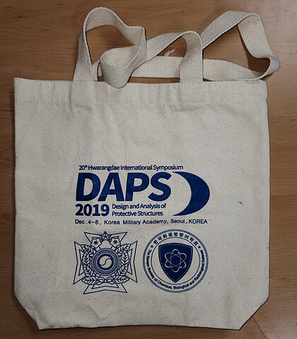 A white bag with blue text on it Description automatically generated