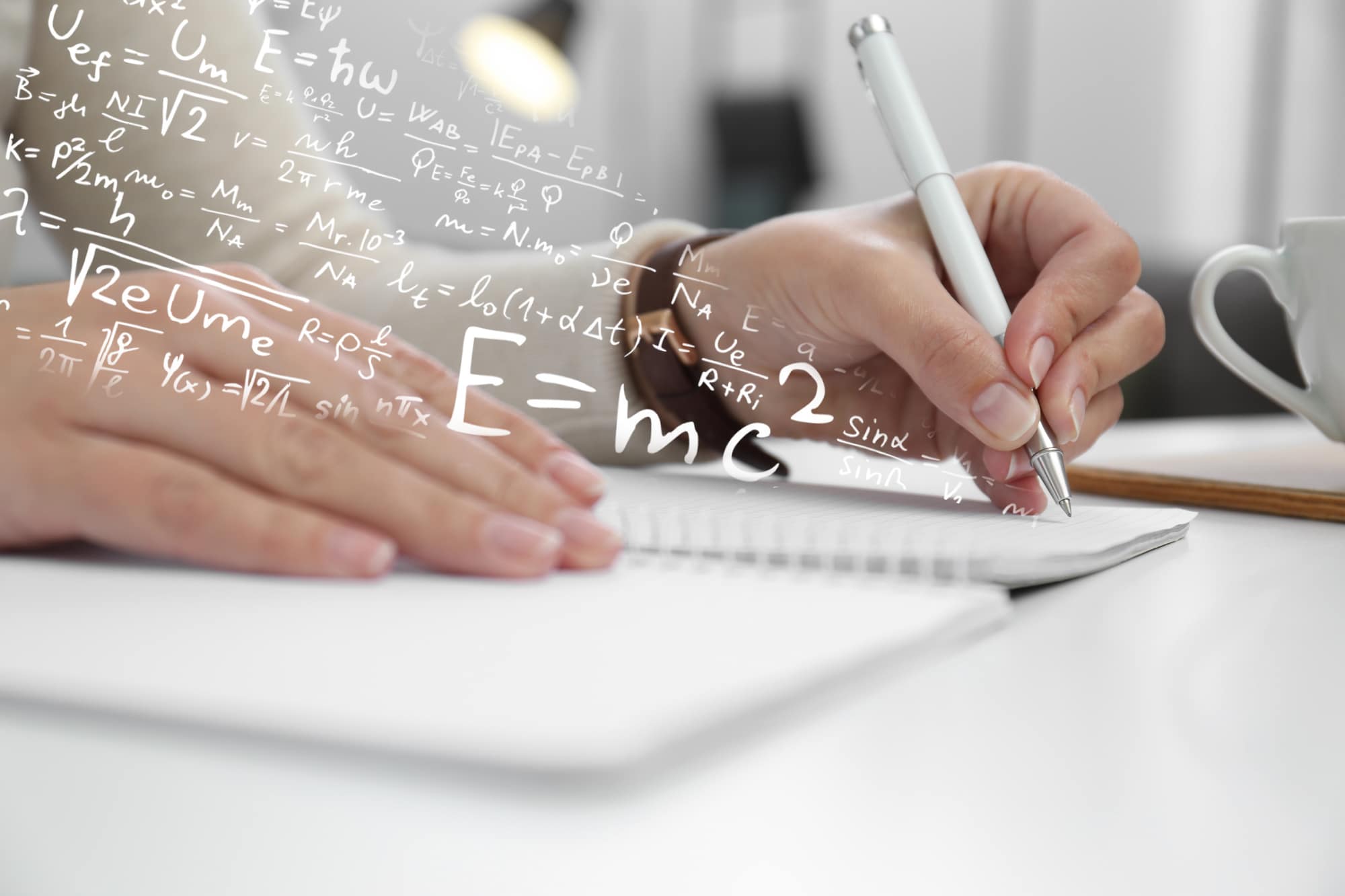 Left-handed woman writing in notebook