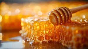 A rich, close-up shot of honey drizzling over a honeycomb