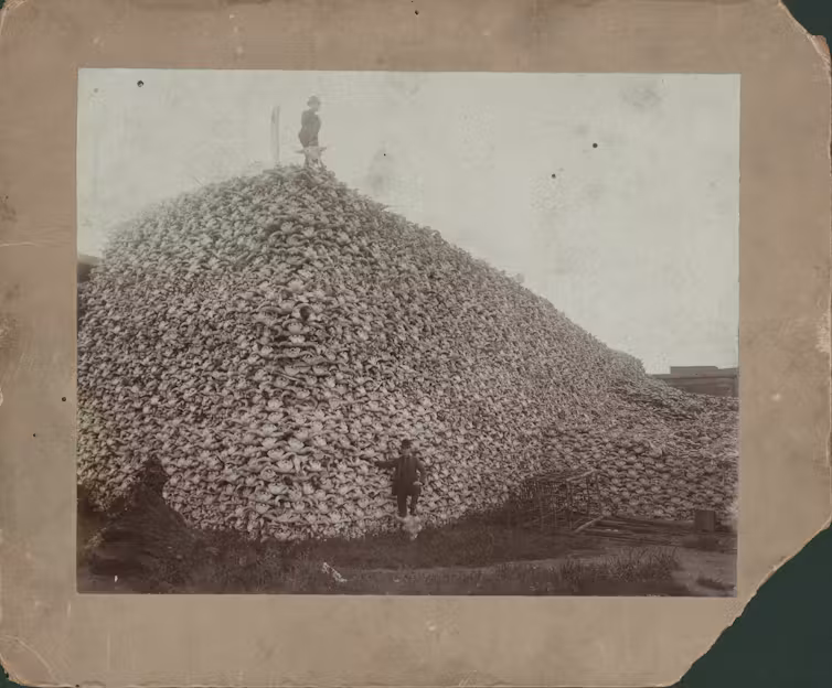 Men standing with pile